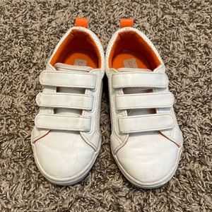 White and orange Velcro tennis shoes
